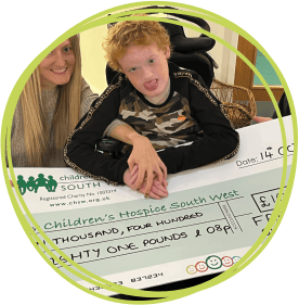 Freddie and his mum Hayley present his cheque 